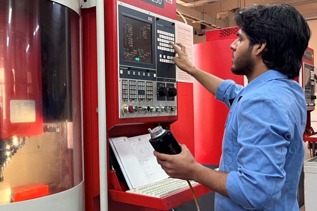 Student at BSDU working on a CNC machine, demonstrating industry-integrated skill development and measurable competency progression.