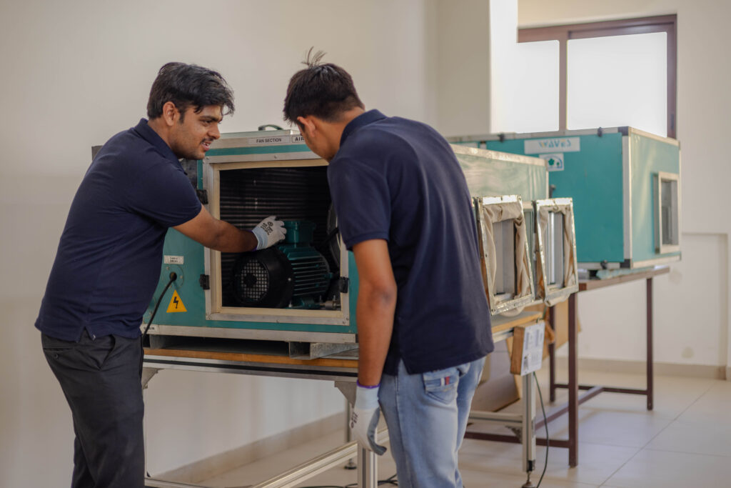 RAC trainer explains the operation of a compressor to a student at Bhartiya Skill University, Jaipur